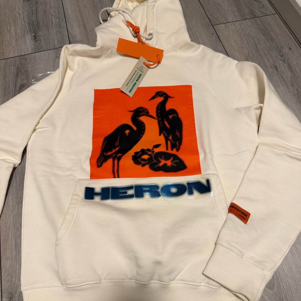 Heron Preston Cream Hoodie with Orange Graphic and Blue Logo
